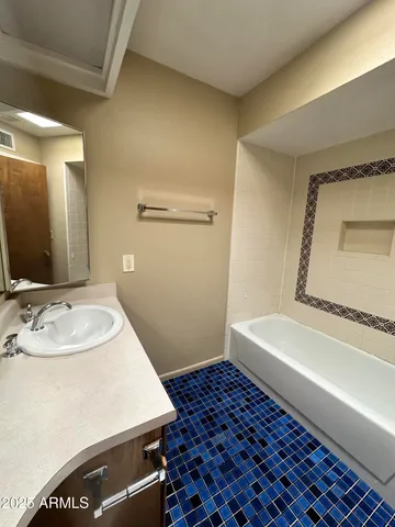 a bathroom with a sink and a mirror