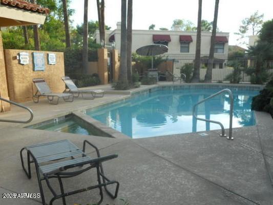 10424 North 11th Place, Unit 2 Phoenix, AZ 85020 - Photo 38 of 41 a view of a patio with a table chairs and a floor to ceiling window