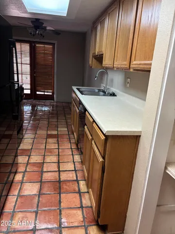 a kitchen that has a sink and a refrigerator