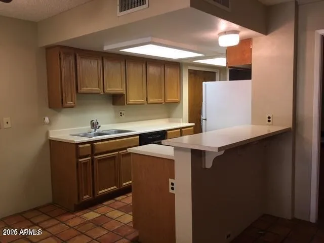 a bathroom with a sink a toilet and a window