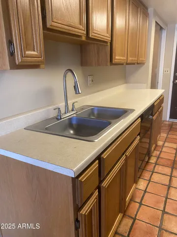 a kitchen with stainless steel appliances a sink stove and cabinets