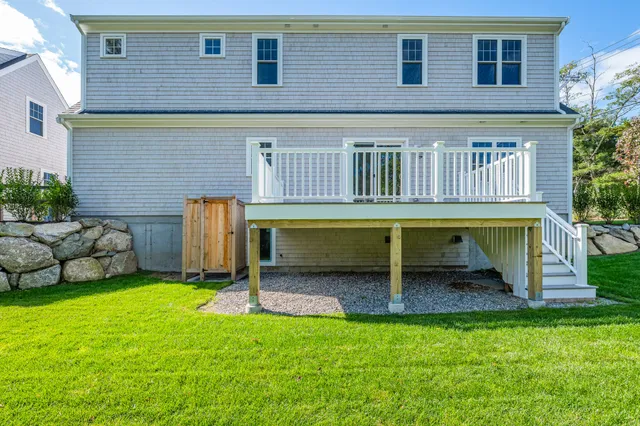 a view of a chair and table in backyard of the house