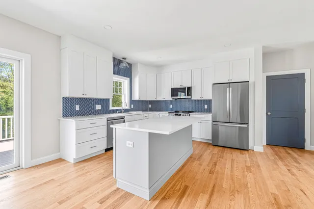 a kitchen with stainless steel appliances a refrigerator sink and cabinets