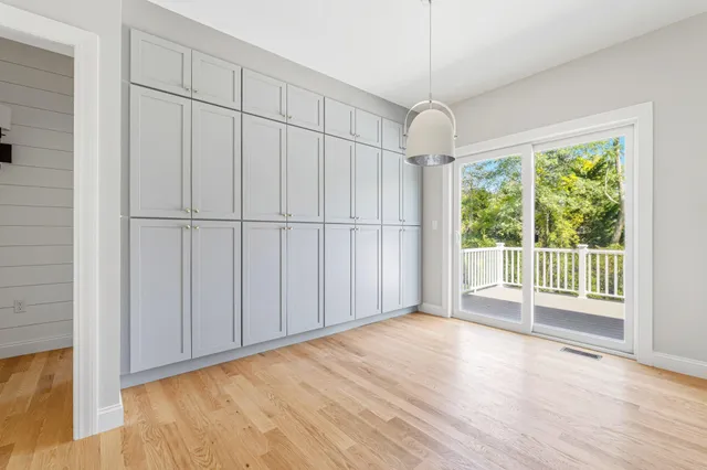 a view of a livingroom with wooden floor and white walls