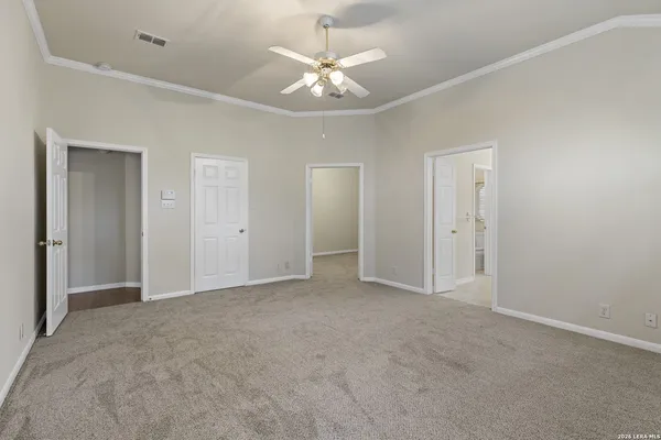 a view of an empty room with a ceiling fan