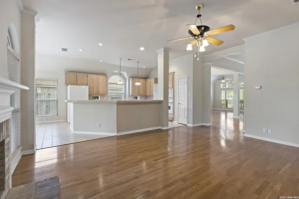 a view of a kitchen with furniture and wooden floor