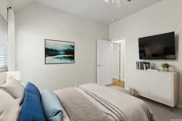 a bedroom with a bed and a flat screen tv
