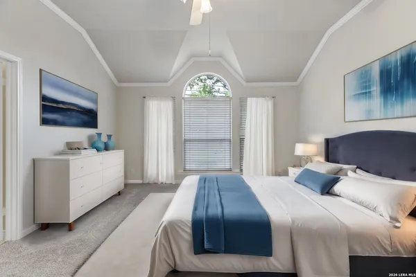 a bedroom with a white bed and a flat screen tv