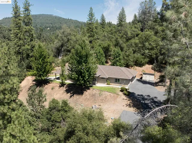an aerial view of a house with yard and outdoor seating