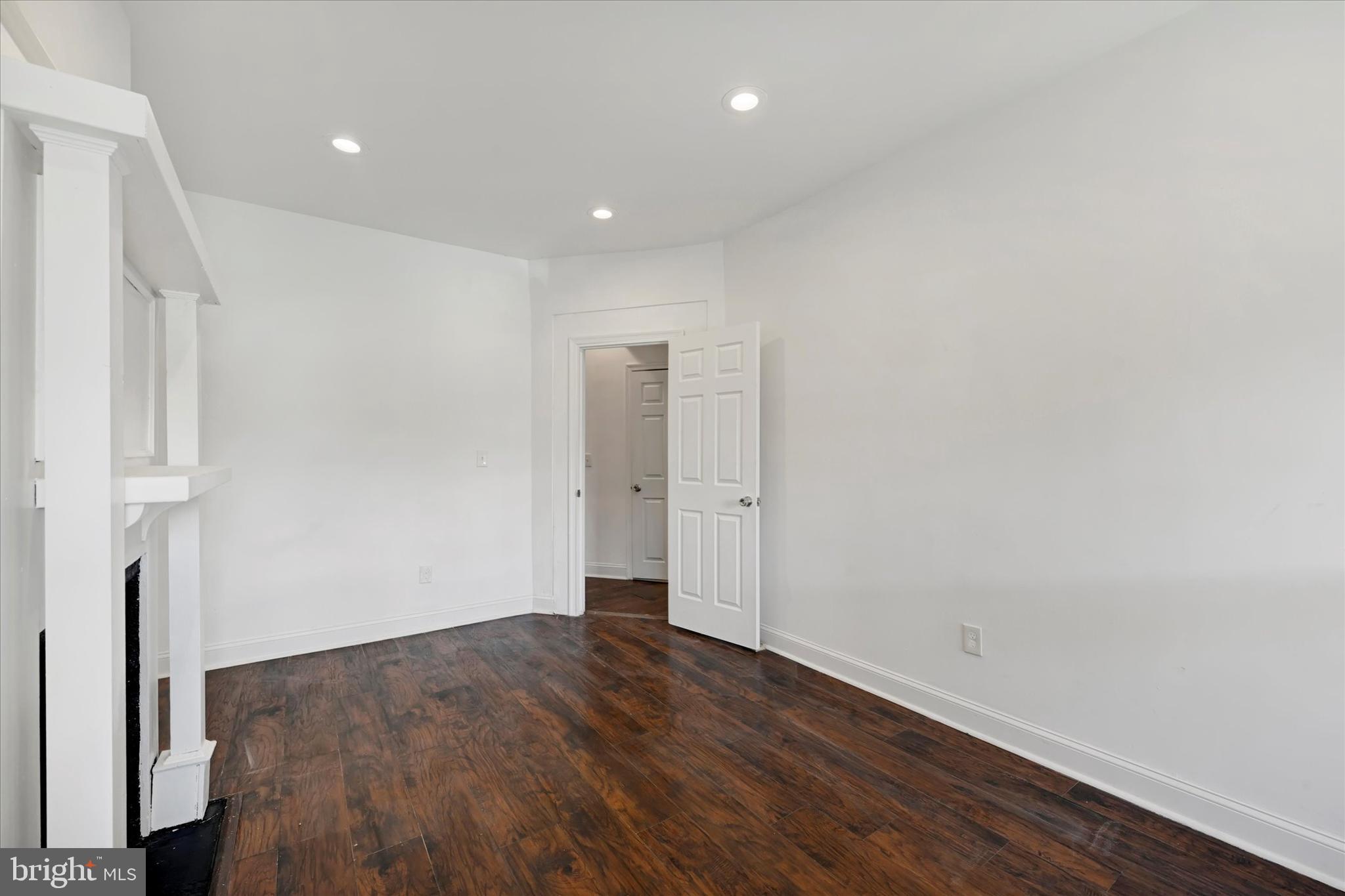 346 East 25th Street Baltimore, MD 21218 - Photo 11 of 31 an empty room with wooden floor and entrance