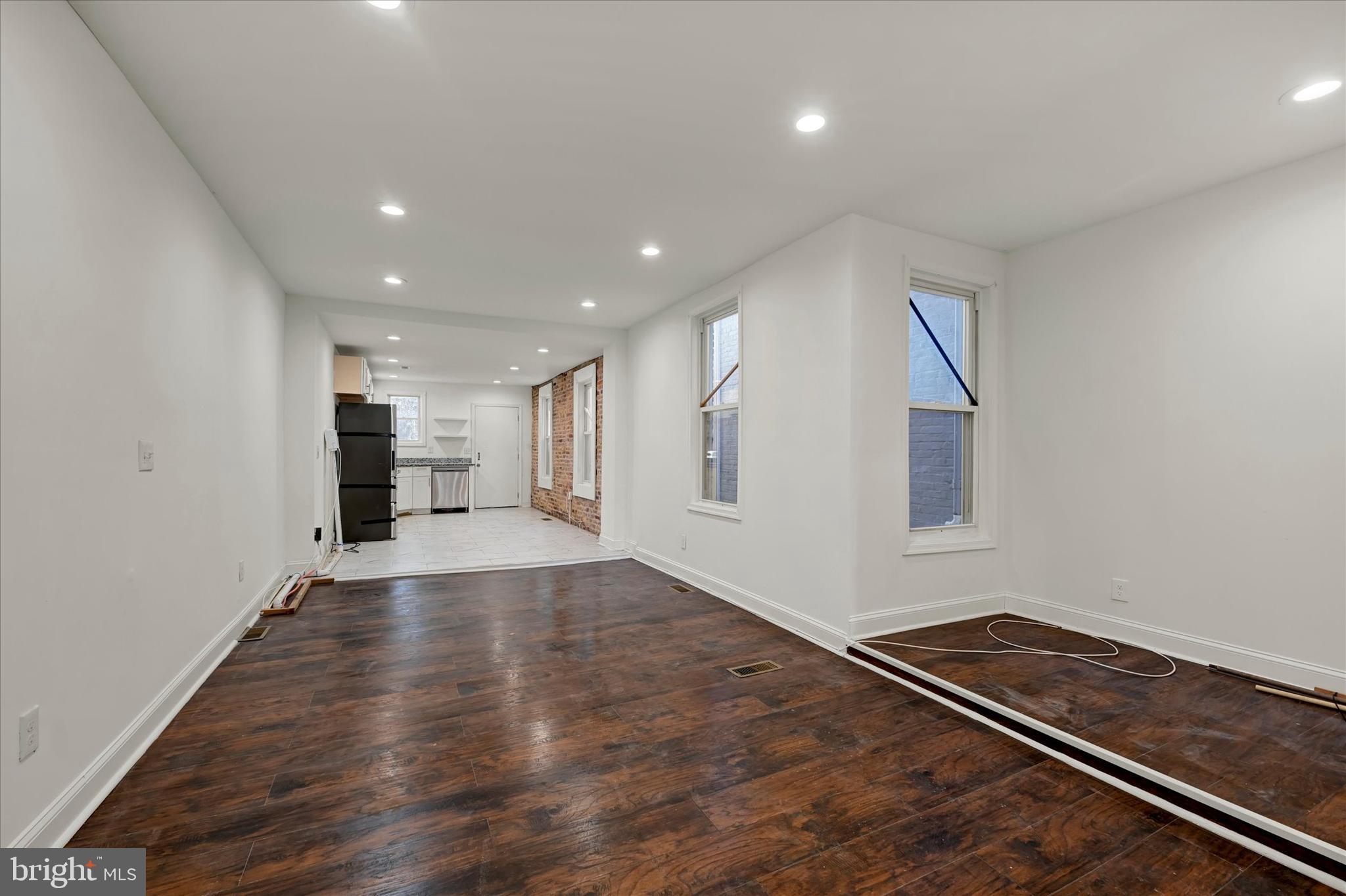 346 East 25th Street Baltimore, MD 21218 - Photo 13 of 31 a view of empty room with wooden floor