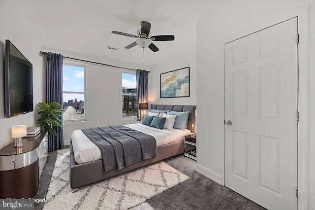 a bedroom with a large bed and a chandelier