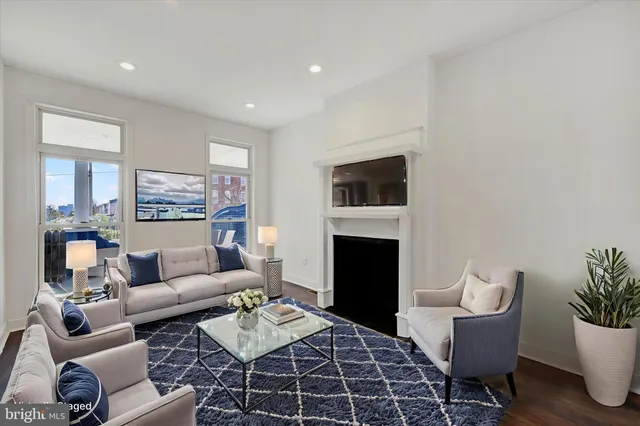 a living room with furniture a rug and a fireplace