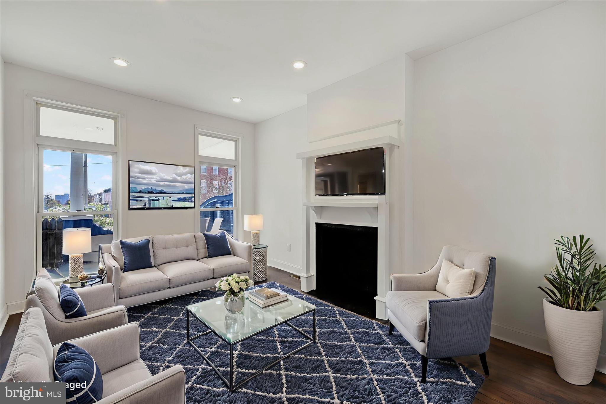 346 East 25th Street Baltimore, MD 21218 - Photo 2 of 31 a living room with furniture a rug and a fireplace