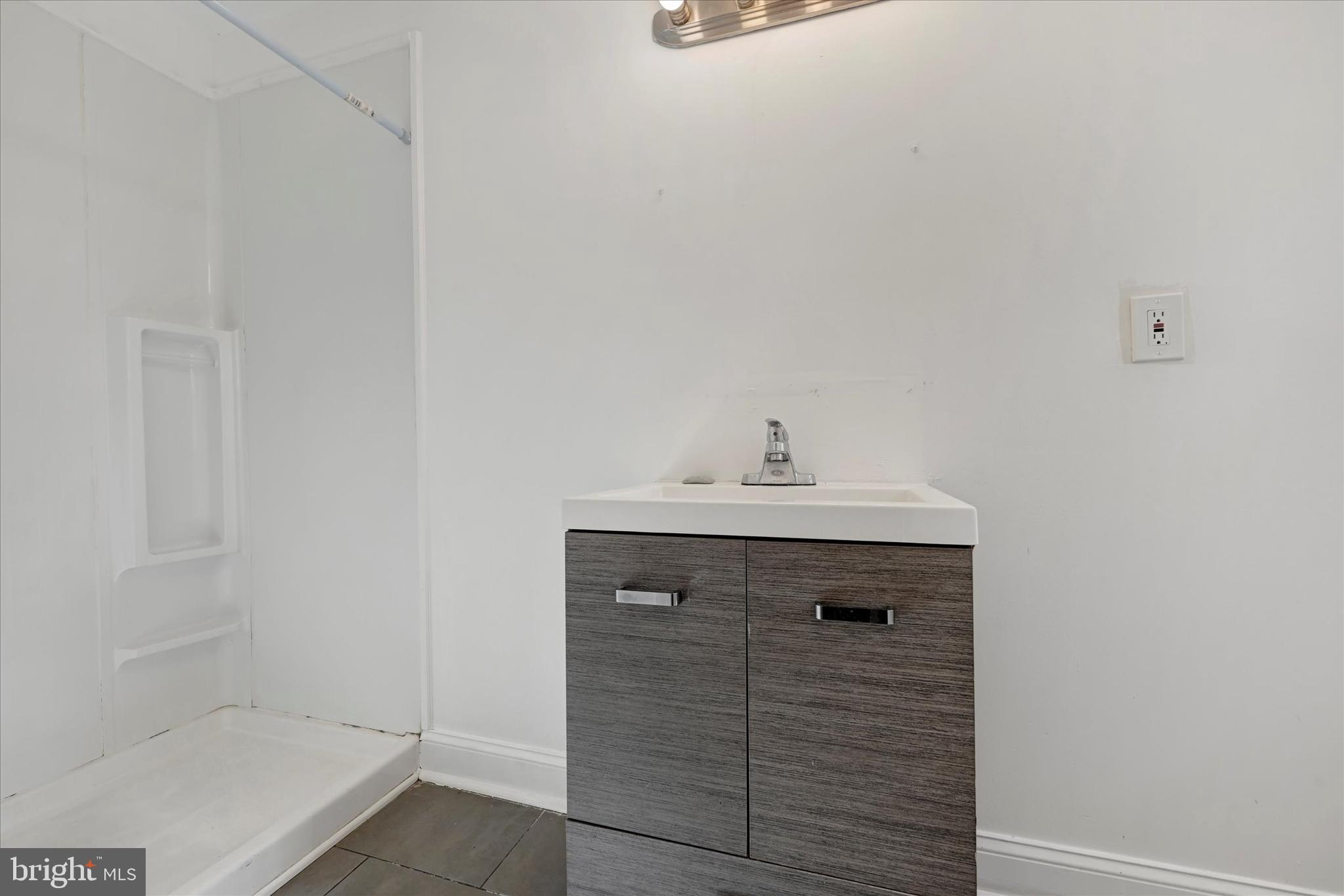 346 East 25th Street Baltimore, MD 21218 - Photo 23 of 31 a bathroom with a sink and vanity