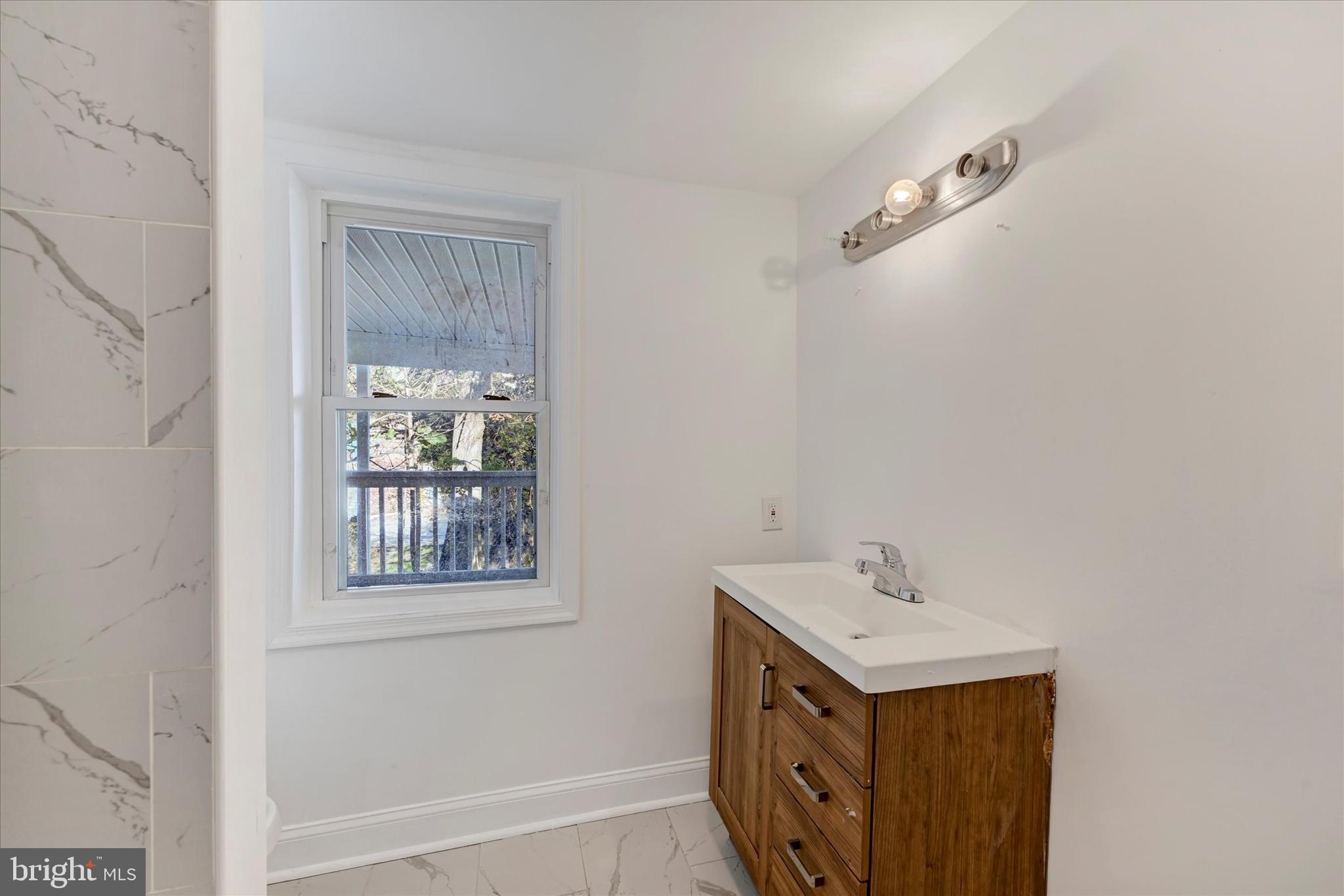346 East 25th Street Baltimore, MD 21218 - Photo 26 of 31 a utility room with a window a sink and dishwasher