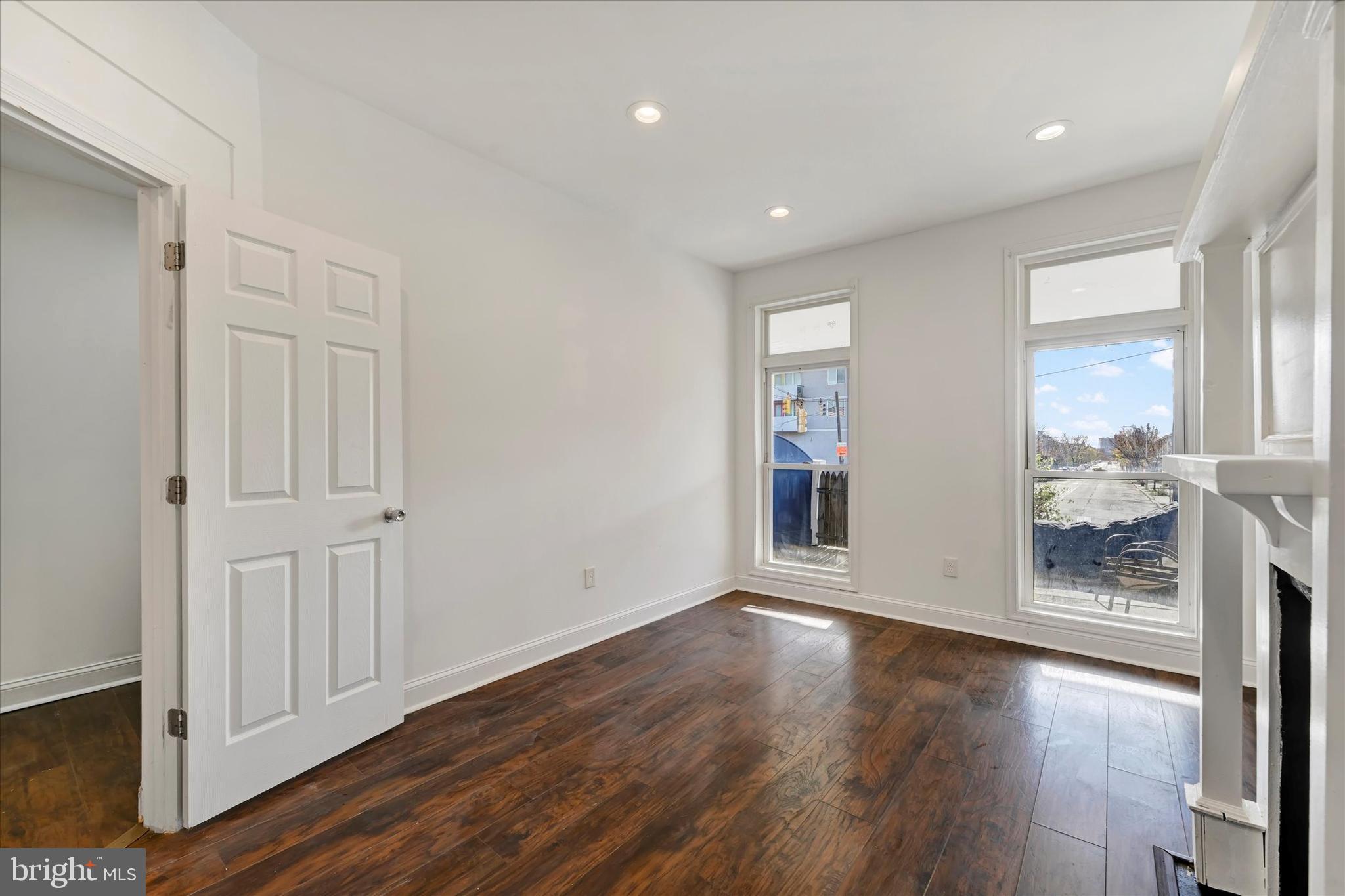 346 East 25th Street Baltimore, MD 21218 - Photo 9 of 31 wooden floor in an empty room with a window