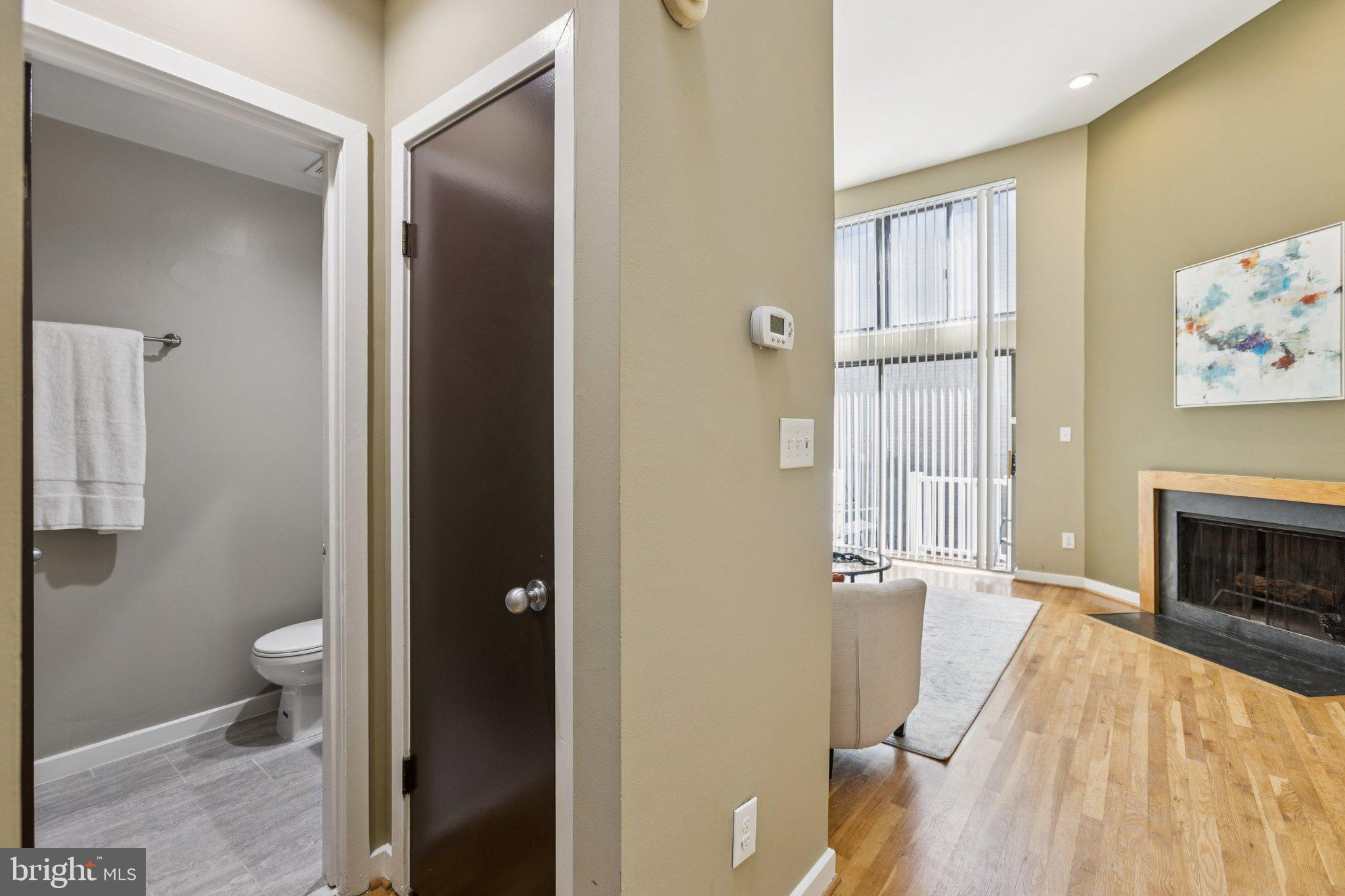 406 15th Street Southeast Washington, DC 20003 - Photo 10 of 39 a view of a hallway with wooden floor and a bathroom