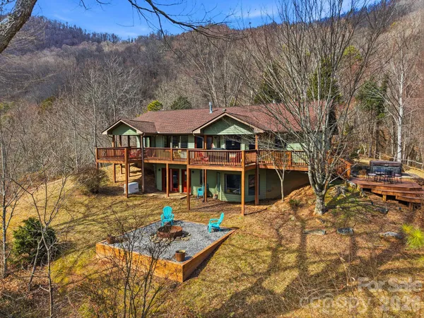 a front view of a house with a yard covered with snow