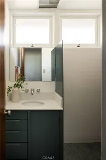 a view of a house with a yard and potted plants