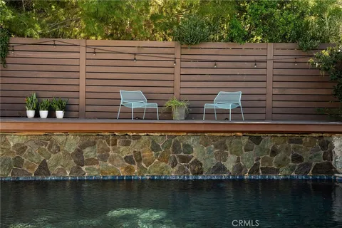 a view of patio with a table and chairs under an umbrella