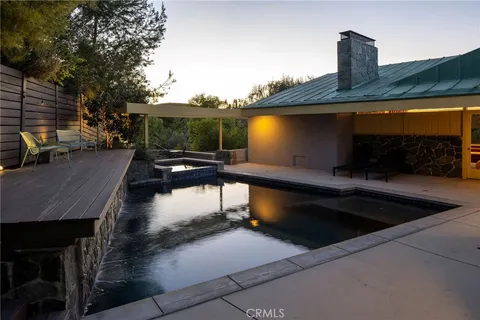 a front view of a house with a swimming pool