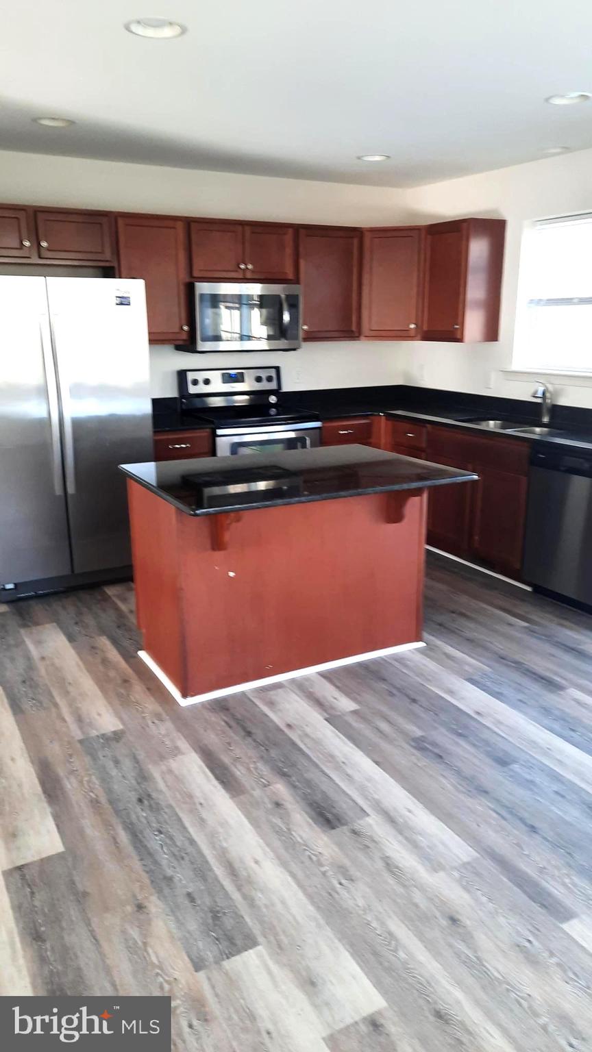 815 Schooner Lane Mechanicsburg, PA 17050 - Photo 2 of 15 a kitchen with stainless steel appliances granite countertop a sink and a stove