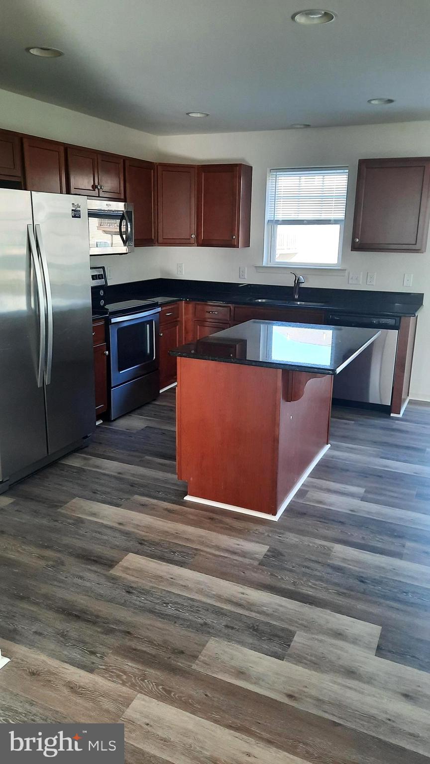 815 Schooner Lane Mechanicsburg, PA 17050 - Photo 3 of 15 a kitchen with stainless steel appliances granite countertop a stove a refrigerator and a sink