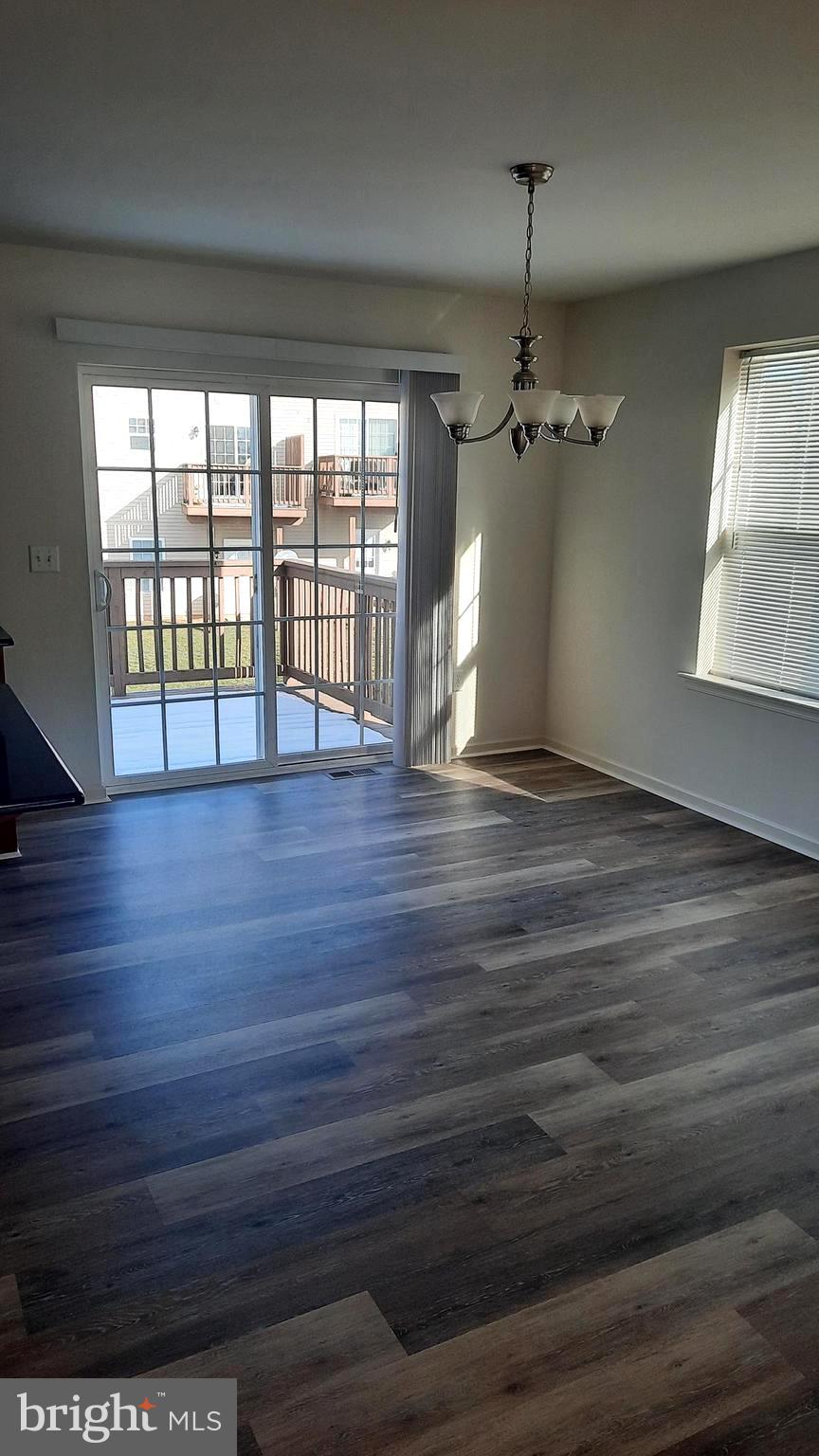 815 Schooner Lane Mechanicsburg, PA 17050 - Photo 4 of 15 a view of an empty room with wooden floor and a window
