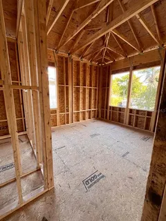 a view of a room with wooden walls and iron stairs