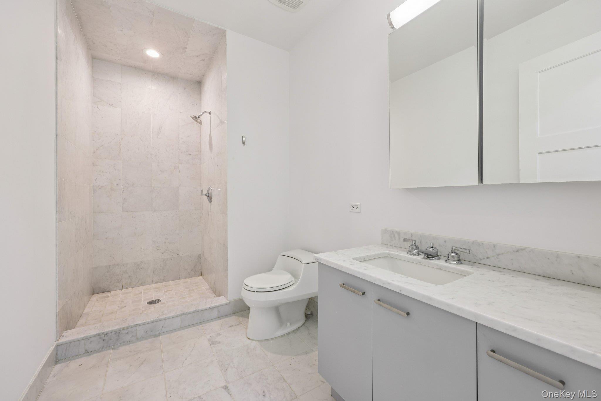 1 Renaissance Square, Unit PH40C White Plains, NY 10601 - Photo 15 of 23 a bathroom with a sink toilet and shower