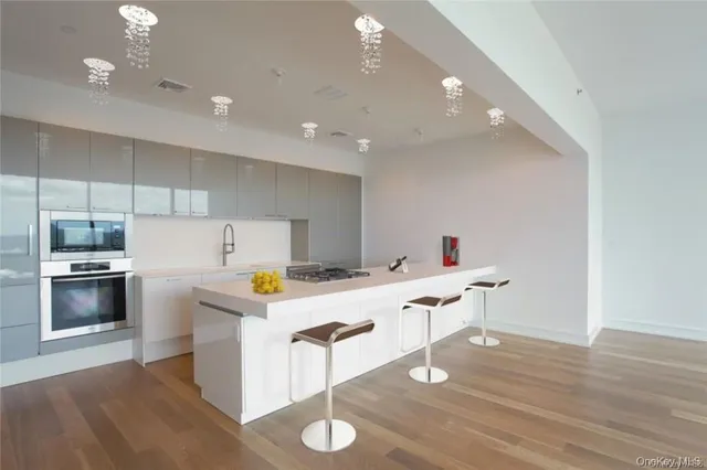 a kitchen with a wooden floor and white cabinets