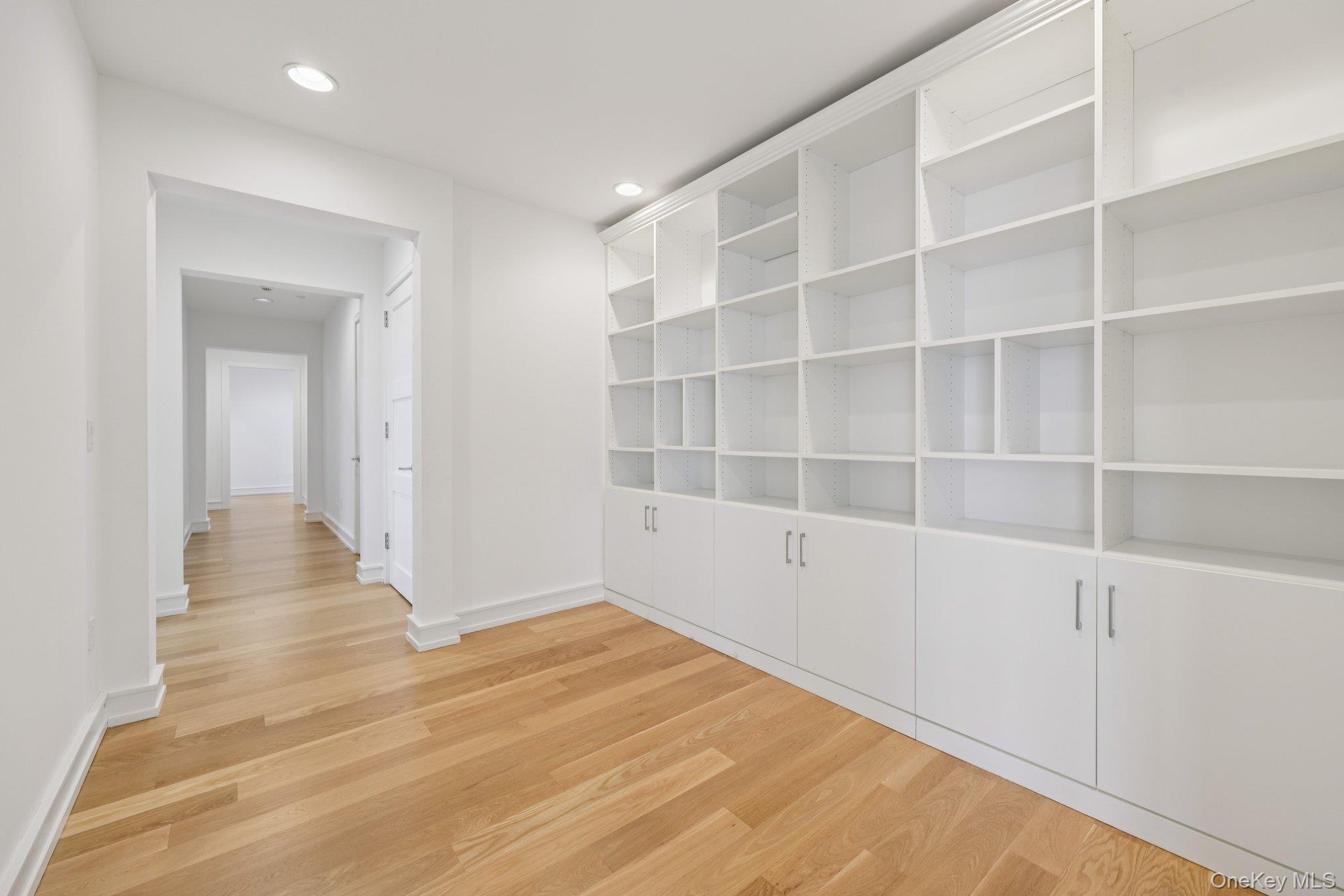 1 Renaissance Square, Unit PH40C White Plains, NY 10601 - Photo 6 of 23 a view of an empty room with wooden floor and a window
