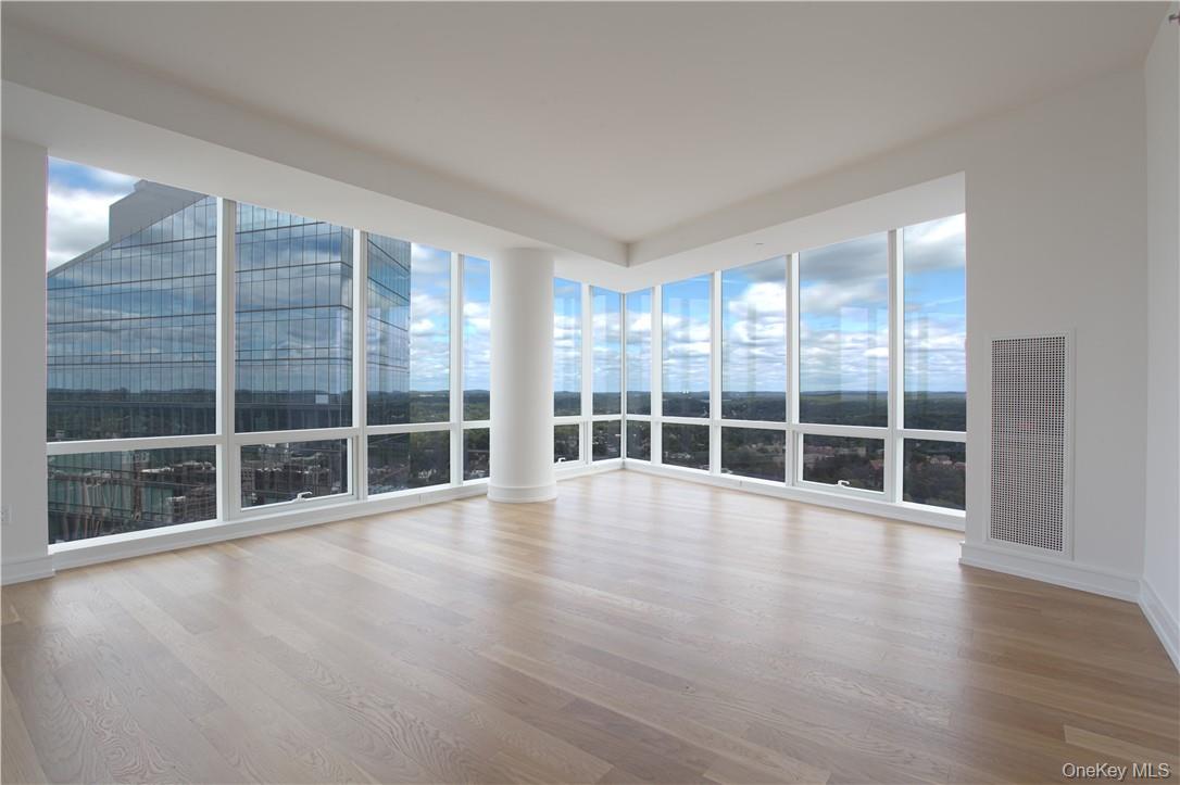 1 Renaissance Square, Unit PH40C White Plains, NY 10601 - Photo 8 of 14 a view of an empty room with wooden floor and windows
