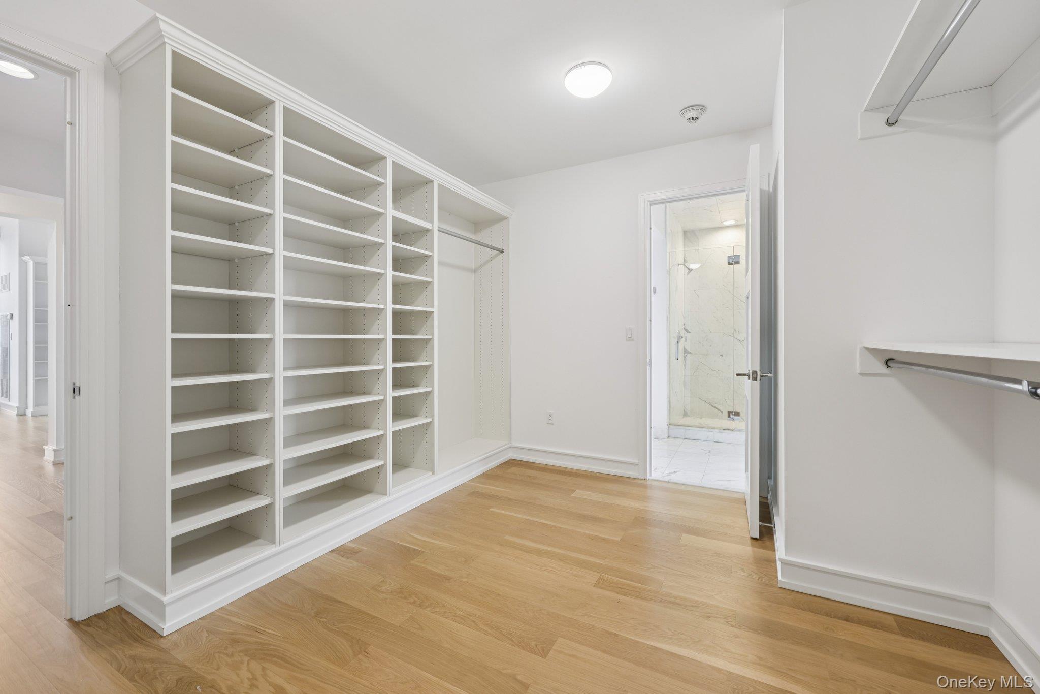 1 Renaissance Square, Unit PH40C White Plains, NY 10601 - Photo 10 of 23 a view of an empty room with wooden floor and a window