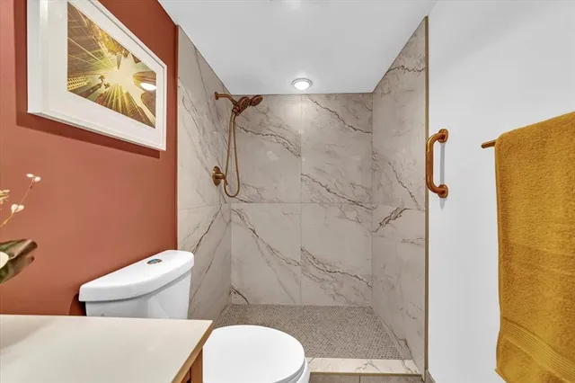 a bathroom with a toilet and a shower