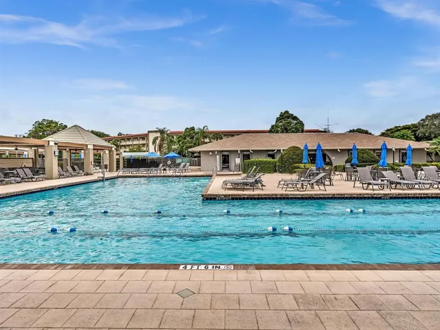 an aerial view of residential houses with outdoor space and seating