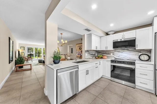 a kitchen with stainless steel appliances granite countertop a stove and cabinets