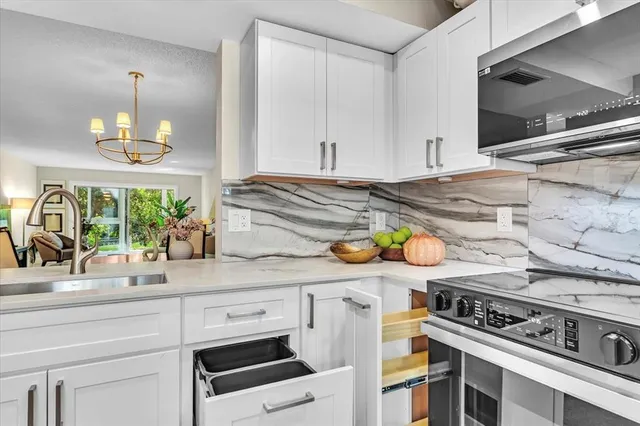 a kitchen with a stove and a white cabinets