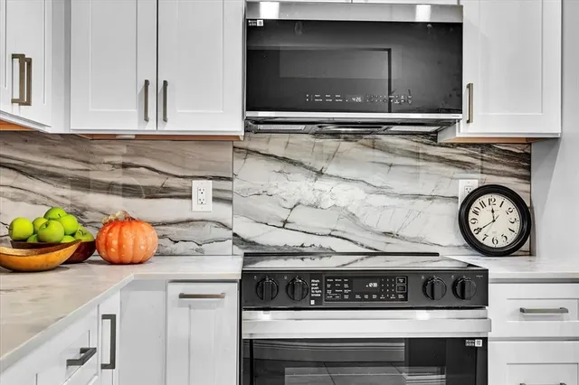 a kitchen with a stove and cabinets