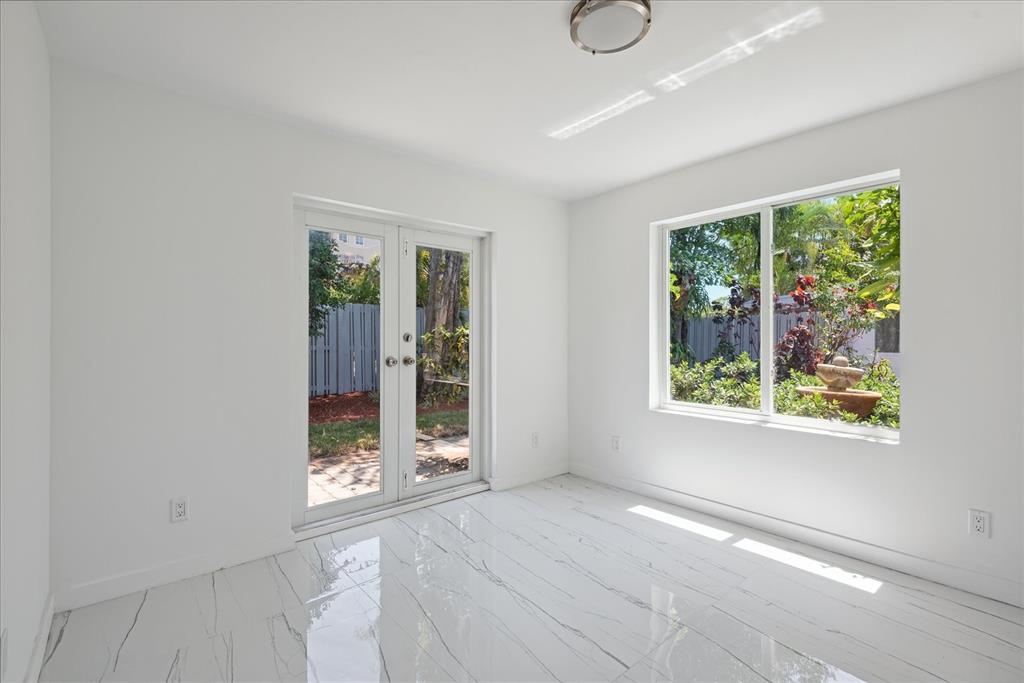 2201-1 Northeast 9th Avenue, Unit 1 Wilton Manors, FL 33305 - Photo 13 of 21 a view of an empty room with a window