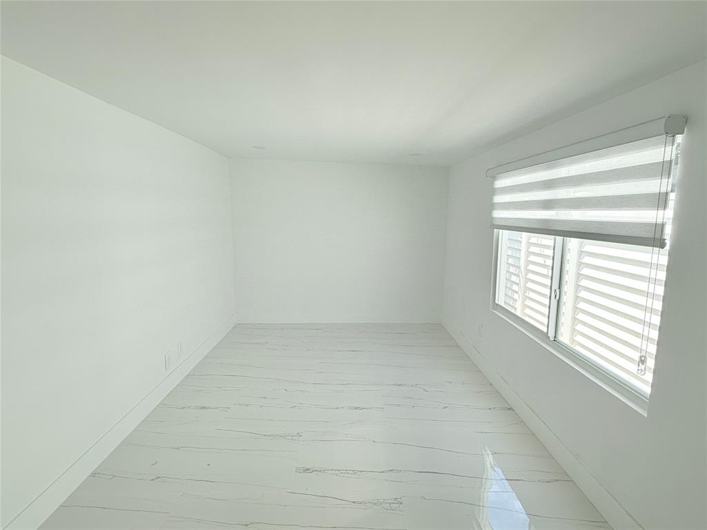 2201-1 Northeast 9th Avenue, Unit 1 Wilton Manors, FL 33305 - Photo 17 of 21 an empty room with a window