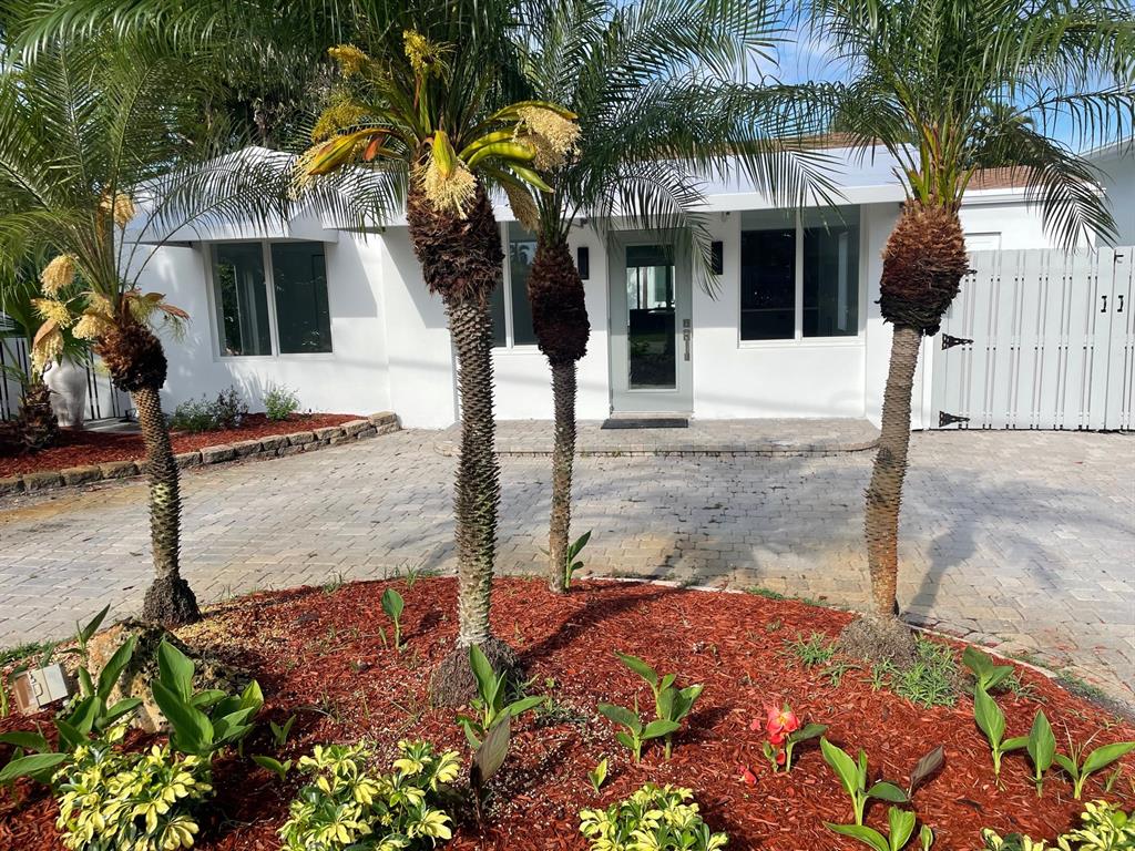 2201-1 Northeast 9th Avenue, Unit 1 Wilton Manors, FL 33305 - Photo 3 of 21 a front view of a house with garden