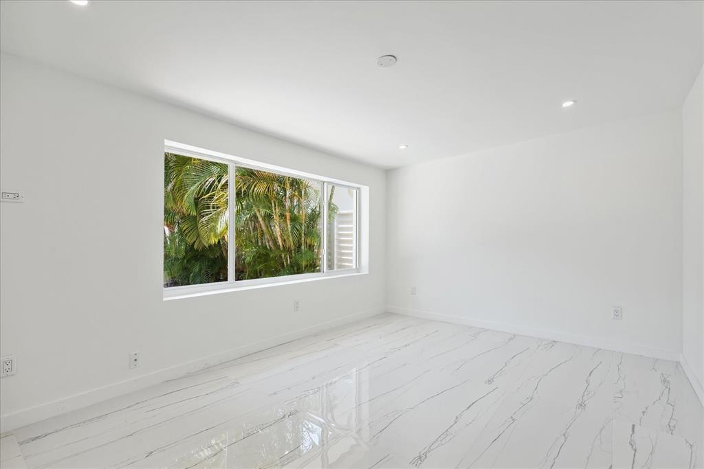 2201-1 Northeast 9th Avenue, Unit 1 Wilton Manors, FL 33305 - Photo 8 of 21 an empty room with a window