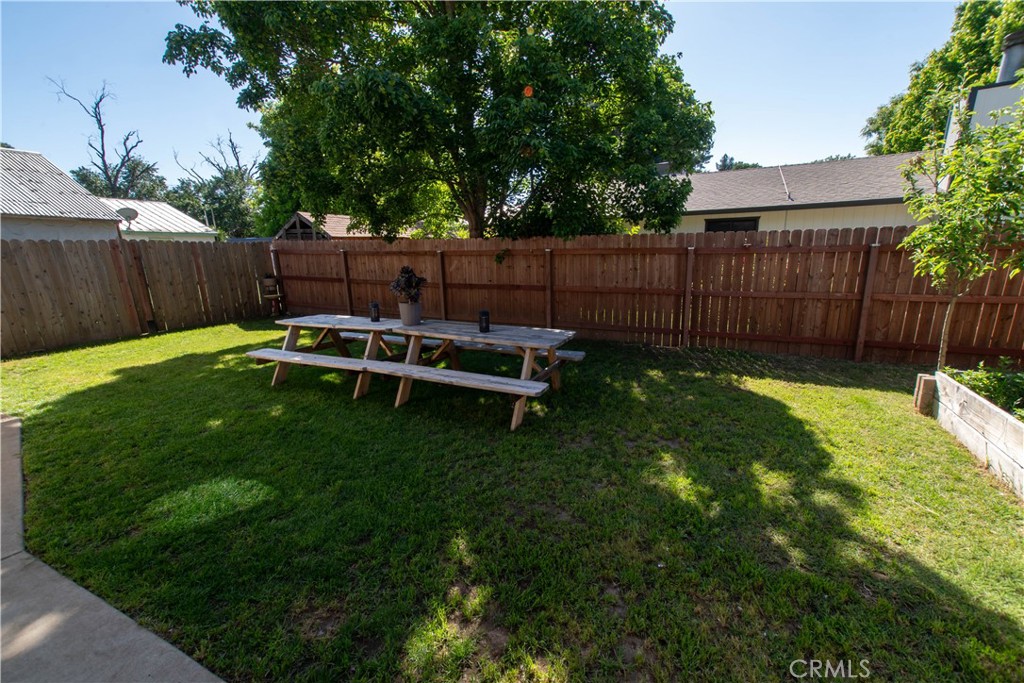 1 San Ramon Drive Chico, CA 95973 - Photo 30 of 42 a view of a backyard with wooden fence and a bench