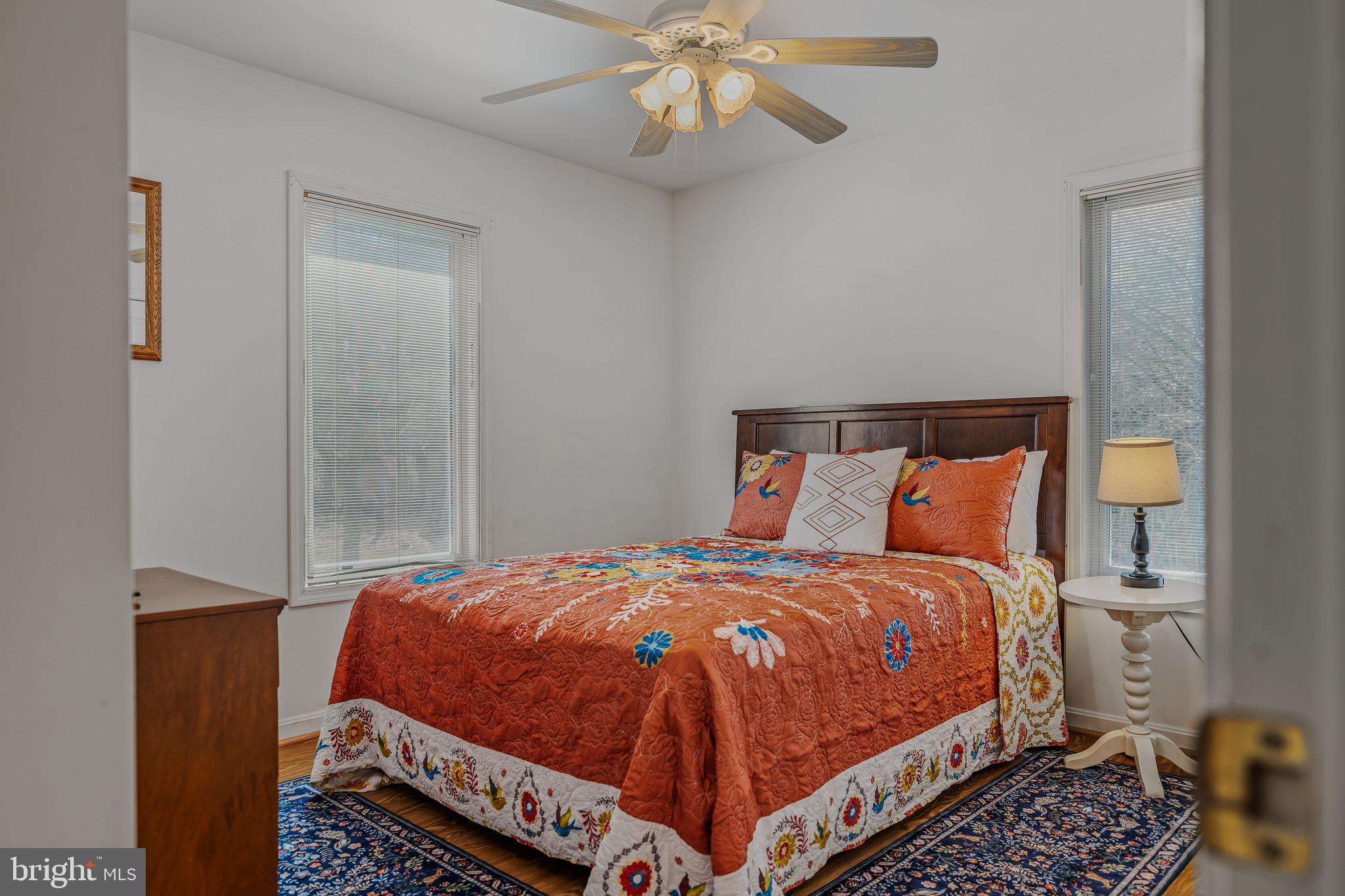 72 Medfords Lane Berkeley Springs, WV 25411 - Photo 16 of 52 a bedroom with a bed and a chandelier
