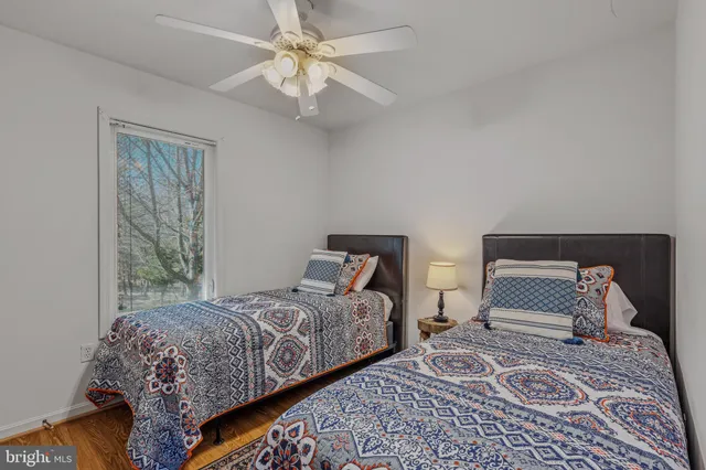 a bedroom with two beds and a chandelier