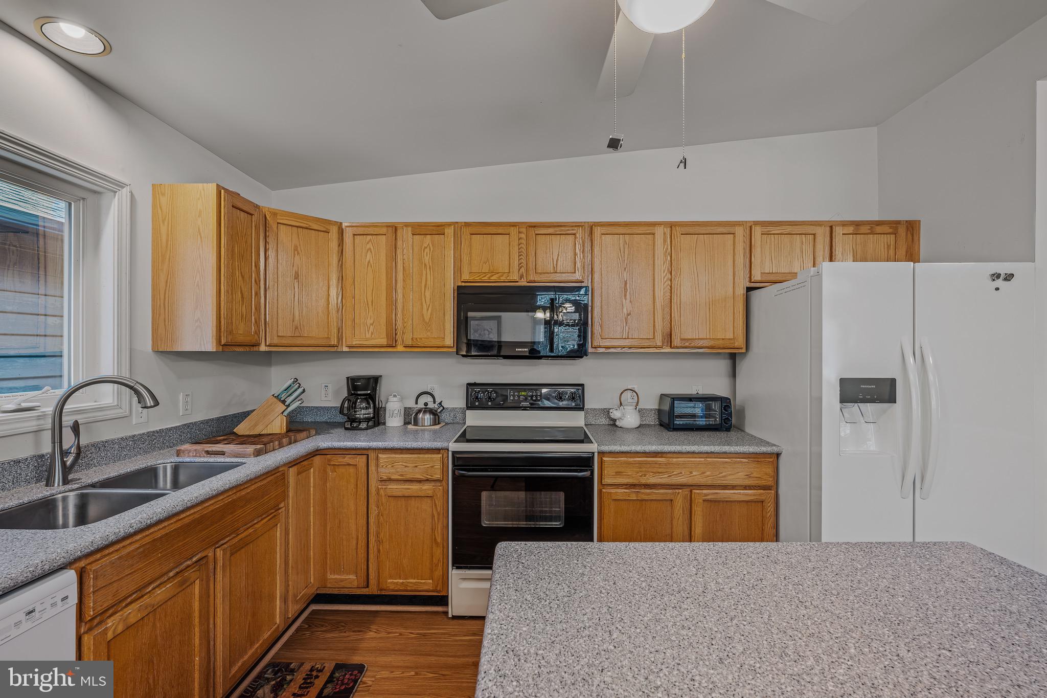 72 Medfords Lane Berkeley Springs, WV 25411 - Photo 2 of 52 a kitchen with a sink a stove and refrigerator