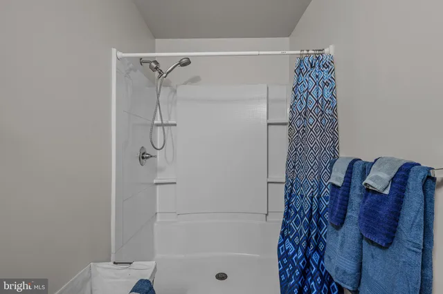 a bathroom with a shower curtain and a shower curtain