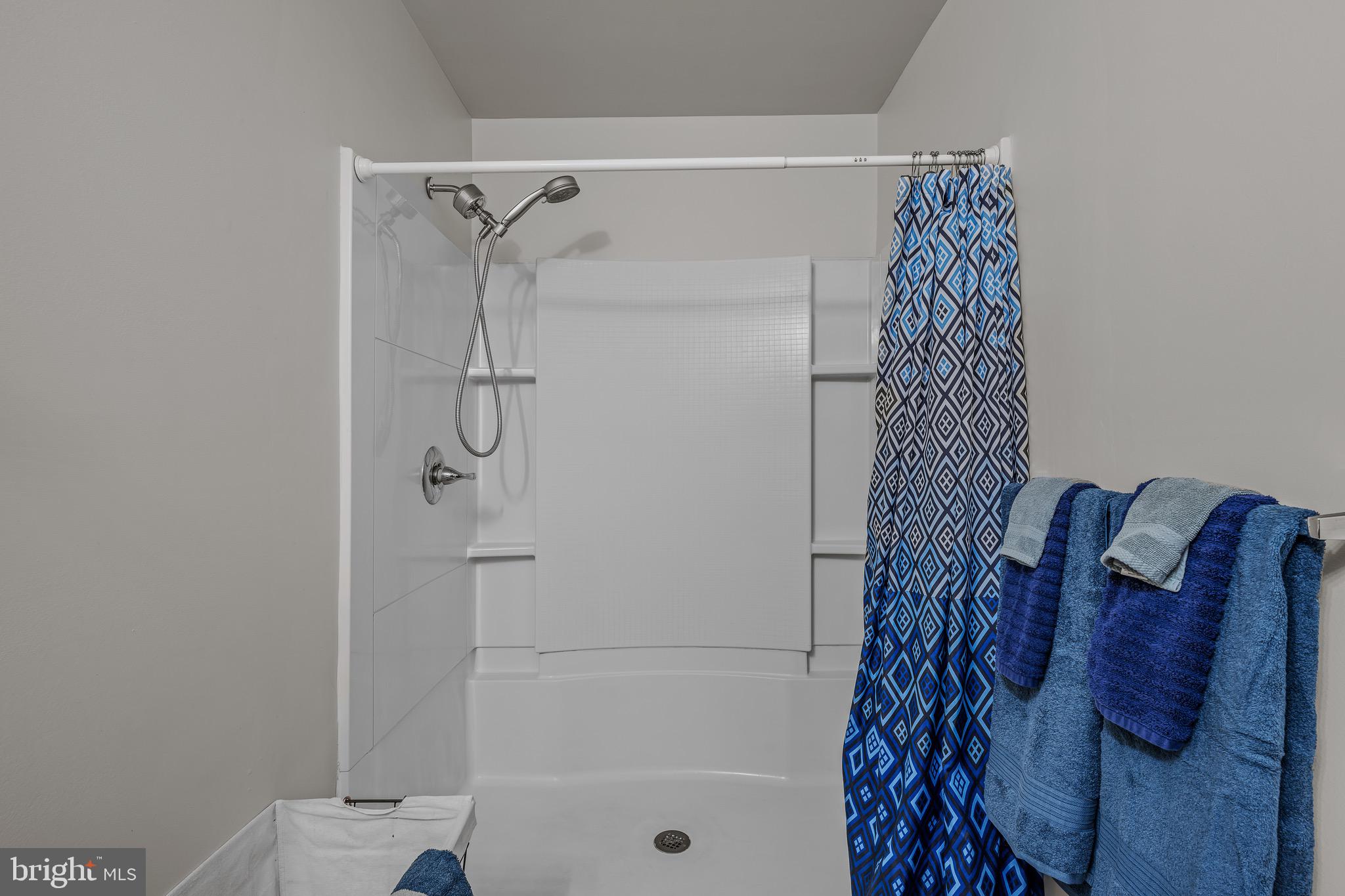 72 Medfords Lane Berkeley Springs, WV 25411 - Photo 25 of 52 a bathroom with a shower curtain and a shower curtain